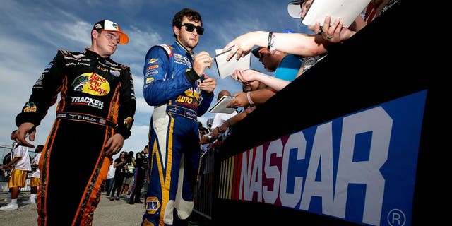 NEWTON, IA - AUGUST 01: Chase Elliott, driver of the #9 NAPA Auto Parts Chevrolet, and Ty Dillon, driver of the #3 Bass Pro Shops/Tracker Boats Chevrolet, sign autographs prior to the start of the NASCAR XFINITY Series U.S. Cellular 250 at Iowa Speedway on August 1, 2015 in Newton, Iowa. (Photo by Sean Gardner/NASCAR via Getty Images)