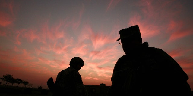 In this Jan. 25, 2007 file photo, the sun sets at a US military base Camp Liberty in Baghdad, Iraq.