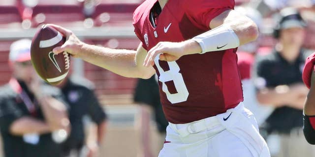 Stanford quarterback Kevin Hogan throws against UC Davis during the first half of an NCAA college football game on Saturday, Aug. 30, 2014, in Stanford, Calif. (AP Photo/Marcio Jose Sanchez)