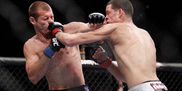Donald Cerrone, left, trades punches with Nate Diaz during their UFC lightweight mixed martial arts match Friday, Dec. 30, 2011 at The MGM Grand Garden Arena in Las Vegas. Diaz won by unanimous decision. (AP Photo/Eric Jamison)