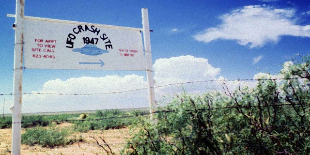 File photo. A sign off route U.S. 285, north of Roswell, New Mexico, points west to the alleged 1947 crash site of a flying saucer on the Corn Ranch.