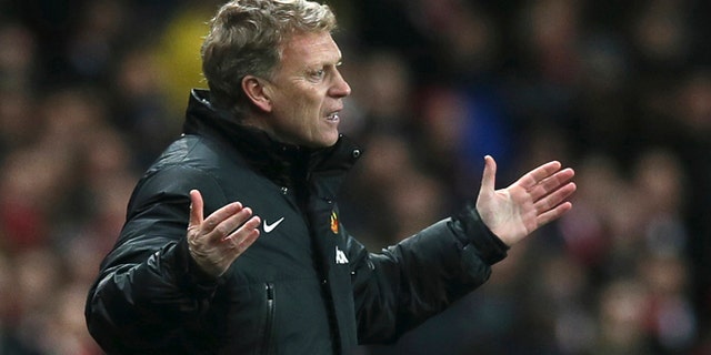 FILE - In this Wednesday, Feb. 12, 2014 file photo Manchester United's manager David Moyes gestures to his team during their English Premier League soccer match between Arsenal and Manchester United at the Emirates stadium in London. Manchester United says manager David Moyes has left the Premier League club after less than a year in charge, amid heavy speculation he was about to be fired. United released a brief statement in its website Tuesday, saying the club "would like to place on record its thanks for the hard work, honesty and integrity he brought to the role." (AP Photo/Alastair Grant, File)