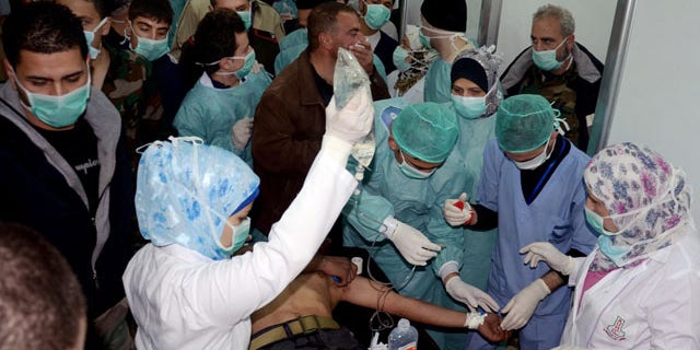 March 19, 2013: In tihs file photo provided by the Syrian official news agency SANA, a Syrian victim who suffered an alleged chemical attack at Khan al-Assal village receives treatment by doctors at a hospital in Aleppo.