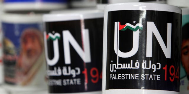 Cups designed as part of the campaign promoting the Palestinians' bid for statehood are displayed in a souvenirs shop in Gaza City, Tuesday, Sept. 13, 2011.