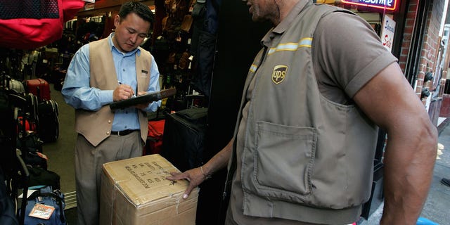 SAN FRANCISCO - DECEMBER 17: UPS driver Doug Lamb delivers a package to a store December 17, 2004 in San Francisco, California. UPS expects to deliver more than 20 million packages on Dec. 21, its busiest shipping day of the year. (Photo by Justin Sullivan/Getty Images)