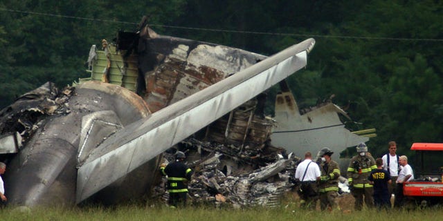 Aug 15, 2013: NTSB investigators work around the tail section of the UPS cargo plane that crashed on approach to the Birmingham-Shuttlesworth International Airport in Birmingham, Ala.