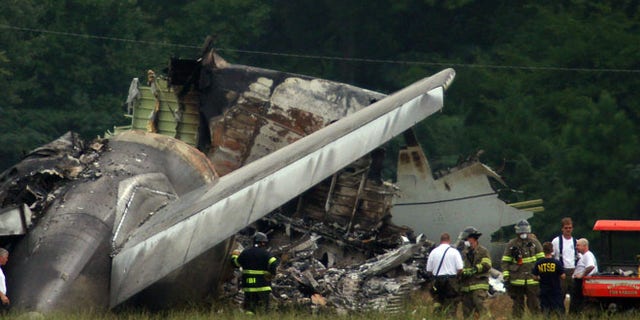 Aug 15, 2013: NTSB investigators work around the tail section of the UPS cargo plane that crashed on approach to the Birmingham-Shuttlesworth International Airport in Birmingham, Ala.