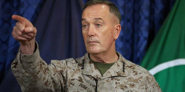 FILE - In this May 28, 2014, file photo, Gen. Joseph Dunford, points during a news conference at the ISAF Headquarters in Kabul, Afghanistan. The top U.S. military commander in Afghanistan said the U.S. has increased its surveillance over the Afghan-Pakistani border, as Pakistan pounds a militant stronghold with airstrikes. (AP Photo/Massoud Hossaini, File)