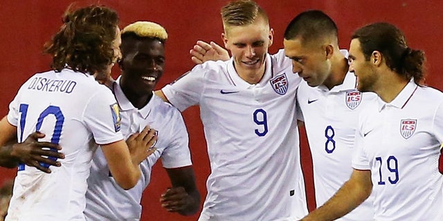 FOXBORO, MA - JULY 10: Teammates congratulate Clint Dempsey #8 of United States after he scored a goal as Frantz Bertin #6 of Haiti, right, disputes the call during the 2015 CONCACAF Gold Cup Group A match between United States and Haiti at Gillette Stadium on July 10, 2015 in Foxboro, Massachusetts. (Photo by Maddie Meyer/Getty Images)