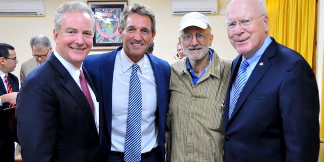 This Wednesday, Dec. 17, 2014 photo shows Alan Gross, second from right, with, from left, Rep. Chris Van Hollen, D-Md., Sen. Jeff Flake, R-Ariz., and Sen. Patrick Leahy, D-Vt. in Havana, Cuba.
