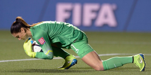 U.S. keeper Hope Solo makes a save against China in the World Cup soccer tournament, Friday, June 26, 2015, in Ottawa.