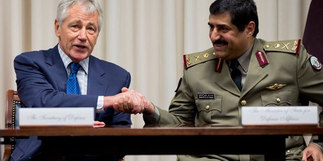 July 14, 2014: Defense Secretary Chuck Hagel, left, shakes hands with Qatari Defense Minister Hamad bin Ali al-Attiyah during a signing ceremony at the Pentagon. (AP Photo/Manuel Balce Ceneta)