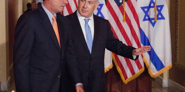 FILE - In this May 24, 2011 file photo, Israeli Prime Minister Benjamin Netanyahu walks with House Speaker John Boehner of Ohio to make a statement on Capitol Hill in Washington. Boehner has invited Netanyahu to address Congress about Iran. (AP Photo/Evan Vucci, File)