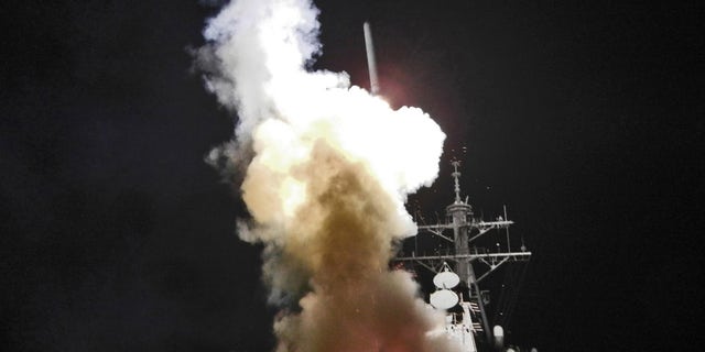 March 19: Arleigh Burke-class guided-missile destroyer USS Barry launches a Tomahawk missile in support of Operation Odyssey Dawn. This was one of approximately 110 cruise missiles fired from U.S. and British ships and submarines that targeted about 20 radar and anti-aircraft sites along Libya's Mediterranean coast. (U.S. Navy)