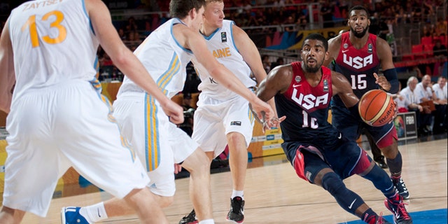 Kyrie Irving of the US goes for the basket between Ukraine players during the Group C Basketball World Cup match, in Bilbao northern Spain, Thursday, Sept. 4, 2014. The 2014 Basketball World Cup competition take place in various cities in Spain from Aug. 30 through to Sept. 14. United States won 95-71. (AP Photo/Alvaro Barrientos)