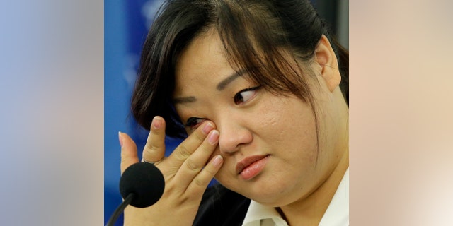 Jin hye Jo wipes a tear as she testifies in Washington D.C. during a hearing of the UN-mandated Commission of Inquiry about human rights in North Korea.