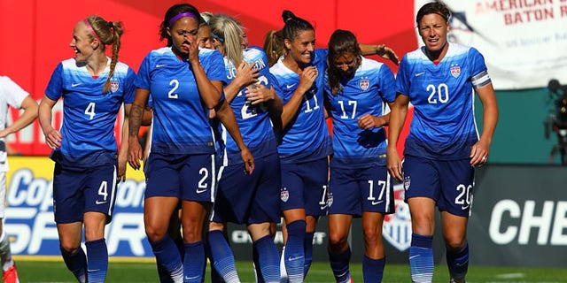 ST. LOUIS, MO - APRIL 4: Members of the US Women's National team celebrate after scoring a goal against New Zealand at Busch Stadium on April 4, 2015 in St. Louis, Missouri. (Photo by Dilip Vishwanat/Getty Images)