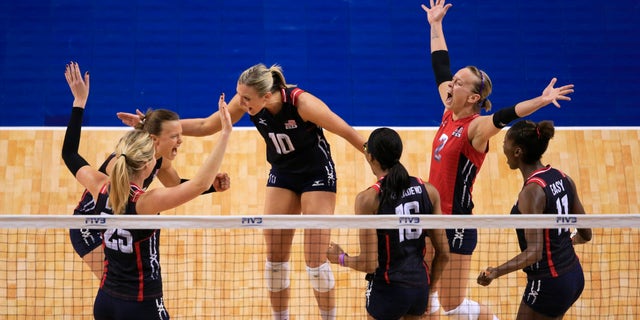 United States' Courtney Thompson, back left, Jordan Larson-Burbach (10), Kayla Banwarth (2) and others celebrate a point against the Dominican Republic in a women's volleyball NORCECA round-robin Olympic qualifying tournament match in Lincoln, Neb., Saturday, Jan. 9, 2016. (AP Photo/Nati Harnik)