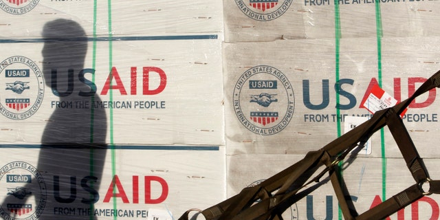 The shadow of a Philippine Army personnel is cast on boxes of relief items from U.S. Agency for International Development (USAID) for the victims of super typhoon Haiyan, at Villamor Air Base in Manila November 13, 2013.