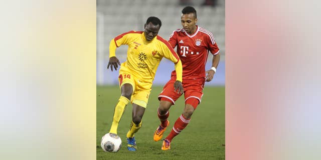 FILE - In this Jan. 9, 2014, file photo, Bayern Munich's Julian Green, right, of Munich, and Balla Jabir, of Al-Merrikh, challenge for the ball, during their friendly soccer match, at Al-Saad stadium in Doha. Green has joined the U.S. soccer team, a glistening talent still developing, a youngster who grew up in Germany with regular trips to see his father in Florida. He will make his debut for the United States against Mexico on Wednesday, April 2. (AP Photo/Osama Faisal, File)