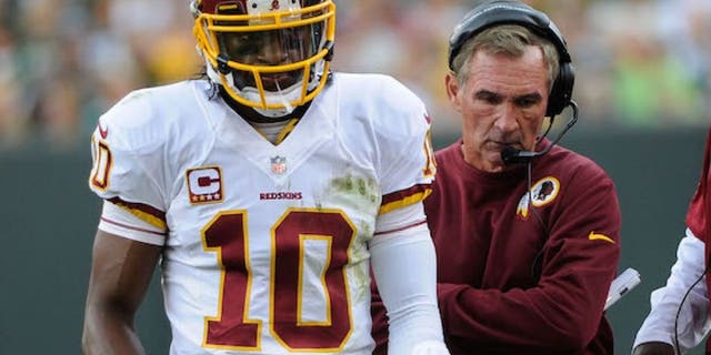 Sep 15, 2013; Green Bay, WI, USA; Washington Redskins quarterback Robert Griffin III (10) and head coach Mike Shanahan walk on the sidelines during the game against the Green Bay Packers in the third quarter at Lambeau Field. Mandatory Credit: Benny Sieu-USA TODAY Sports