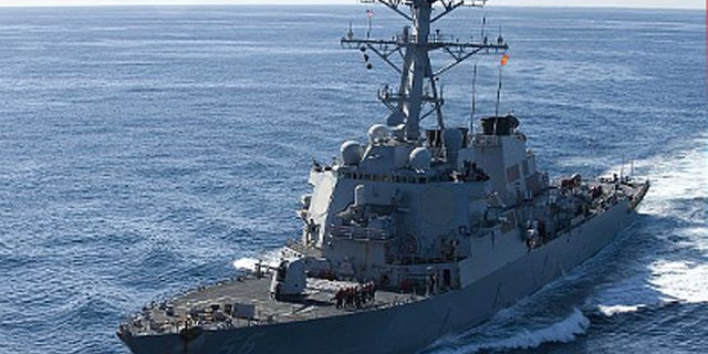 Dec. 5, 2010: The guided-missile destroyer USS John S. McCain approaches the aircraft carrier USS George Washington for a fueling at sea.