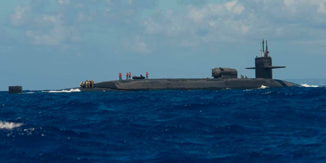 The USS Michigan is more than 560 feet long and weighs more than 18,000 tons when submerged and carries up to 154 Tomahawk cruise missiles.