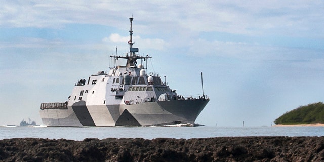 In this photo provided by the U.S. Navy, the USS Freedom littoral combat ship pulls into Pearl Harbor, Hawaii.
