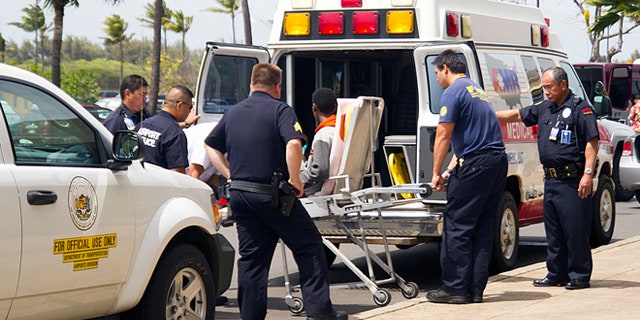 April 20, 2014: In this file photo, a 15-year-old boy, seen sitting on a stretcher center, who stowed away in the wheel well of a flight from San Jose, Calif., to Maui is loaded into an ambulance at Kahului Airport in Kahului, Maui, Hawaii.