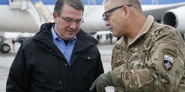 Feb. 21, 2015: In this file photo, U.S. Secretary of Defense Ash Carter, left, walks with U.S. Army Gen. John Campbell upon arrival at Hamid Karzai International Airport in Kabul, Afghanistan. (AP)