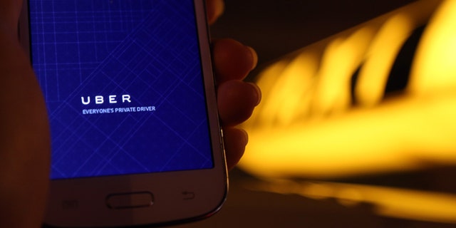 BERLIN, GERMANY - SEPTEMBER 02: In this photo illustration, a woman uses the Uber app on an Samsung smartphone on September 2, 2014 in Berlin, Germany. Uber, an app that allows passenger to buy rides from drivers who do not have taxi permits, has had its UberPop freelance driver service banned in Germany after a complaint by Taxi Deutschland, a trade association of taxi drivers in the country. The company, which operates in 42 countries over 200 cities worldwide, plans to both appeal the decision made by a court in Frankfurt as well as, at the risk of heavy fines, continue its services in Germany until a final decision has been made on the matter. (Photo by Adam Berry/Getty Images)