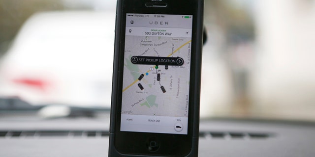 An Uber app is seen on an iPhone in Beverly Hills, California, December 19, 2013.