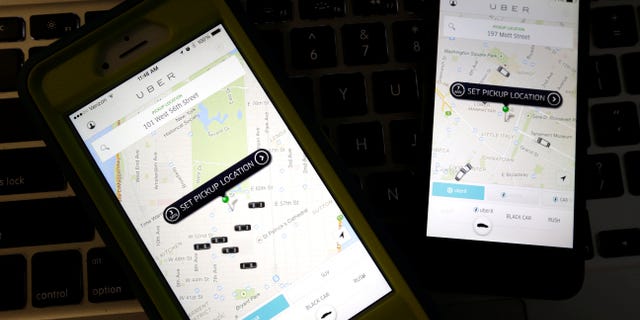 Smartphones display Uber car availability in New York.