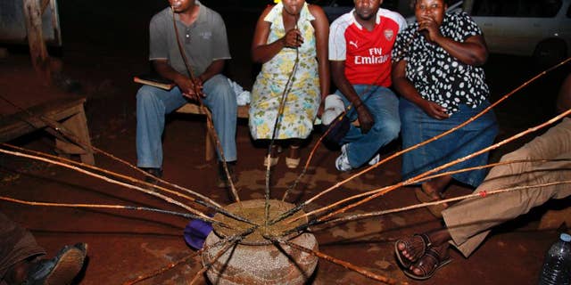 In this photo taken Sunday, Oct. 18, 2015, Ugandans drink a local brew known as "malwa" at the Charismatic Club in the Kitintale district of Kampala, Uganda. With beer sales slowing in North America and Europe, Anheuser-Busch InBev has agreed to pay more than $100 billion for rival SABMiller, in large part to tap burgeoning growth in Africa, where many people still buy their beer from small neighborhood brewers. (AP Photo/Stephen Wandera)