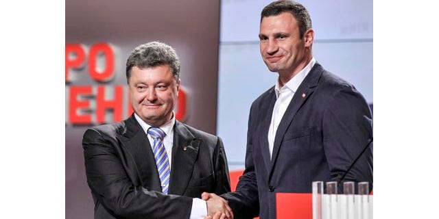 May 25, 2014: Ukrainian presidential candidate Petro Poroshenko, left, shake hands with Kiev mayoral candidate Vitali Klitschko during their press conference in Kiev. (AP Photo/Mykola Lazarenko, Pool)