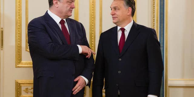 Ukraine's President Petro Poroshenko, left, talks with Hungarian Prime Minister Viktor Orban in Kiev, Ukraine, Friday, Feb. 13, 2015. (AP Photo/Mikhail Palinchak, Pool)