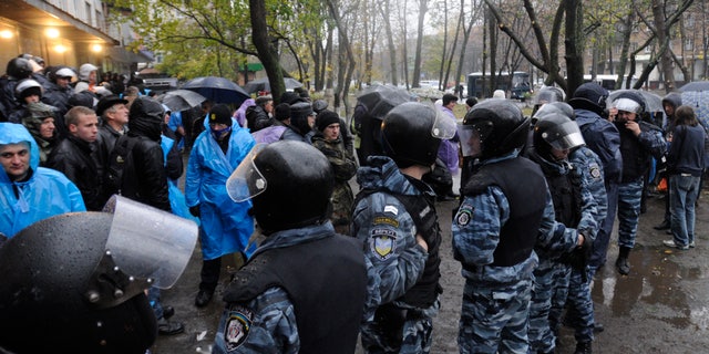 Nov. 2, 2012: Riot police separate opposition and pro-government activists outside an election precinct in Kiev where the opposition alleged election fraud in Kiev, Ukraine.