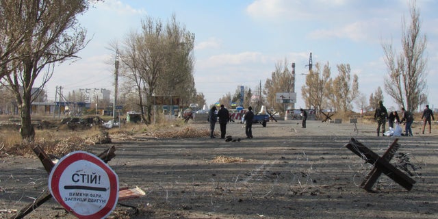 November 2, 2014 - Investigators at site of a car explosion at a Ukraine-held checkpoint on the outskirts of Mariupol, The blast killed 2 and injured 1 Ukrainian servicemen, according to Andriy Lysenko, Ukraine's National Security spokesman. Ukraine on Friday accused Russia of sending dozens of tanks and other heavy weapons into its rebel-controlled easternmost regions.