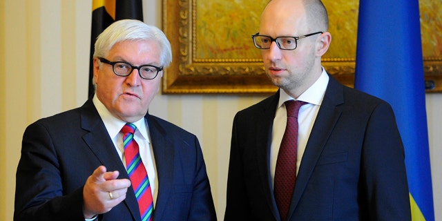 June 24, 2014: German Foreign Minister Frank-Walter Steinmeier, left, talks with Ukrainian Prime Minister Arseniy Yatsenyuk during a meeting in Kiev, Ukraine. (AP Photo/Andrew Kravchenko, Pool)