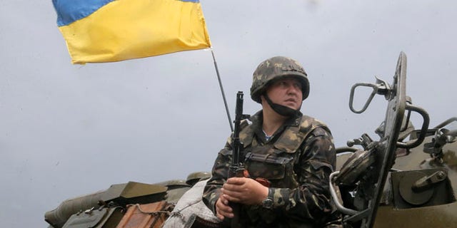 A Ukrainian soldier takes position during a battle with pro-Russian separatist fighters in Slovyansk, Ukraine, Saturday, May 31, 2014. The Ukrainian Acting Defence Minister said on Friday that troops had ousted separatists from southern and western parts of the Donetsk region and north of the Luhansk region. (AP Photo/Efrem Lukatsky)