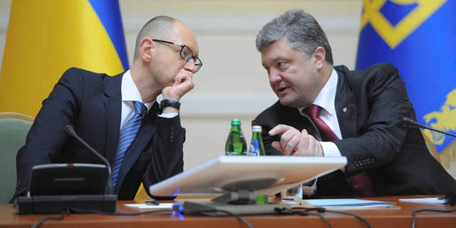 September 10, 2014: Ukrainian President Petro Poroshenko, right, talks with Prime Minister Arseniy Yatsenyuk in Kiev, Ukraine. (AP Photo/Andrew Kravchenko, Pool)