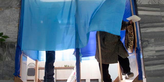 October 26, 2014: People fill their ballots during parliament elections in a polling station in Volnovakha, a village on the front line of fighting between Ukrainian government forces and rebels in eastern Ukraine. (AP)