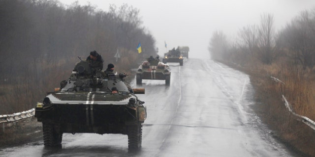 Feb. 1, 2015: Ukranian military vehicles are seen driving on the road towards the town of Artemivsk. Fighting between government and Russian-backed separatist forces in eastern Ukraine has intensified in recent days as rebels seek to encircle the town of Debaltseve, which hosts a strategically important railyway hub. (AP Photo/Petr David Josek)