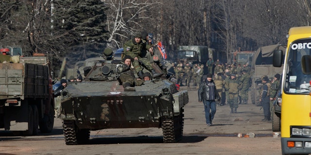 Feb. 23, 2015: Russia-backed rebels ride on an armored vehicle in the center of Debaltseve, Ukraine. (AP Photo/Vadim Ghirda)