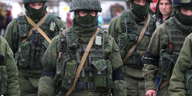 March 4, 2014: Pro Russian soldiers guard Ukraine's infantry base in Perevalne, Ukraine. Russian President Vladimir Putin said Moscow reserves the right to use all means to protect Russians in Ukraine as U.S. Secretary of State John Kerry was on his way to Kiev. Tensions remained high in the strategic Ukrainian peninsula of Crimea with troops loyal to Moscow firing warning shots to ward off protesting Ukrainian soldiers. (AP/Sergei Grits)