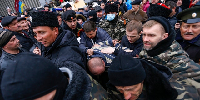April 13, 2014: Pro-Russian protesters escort a man detained in eastern Ukraine.