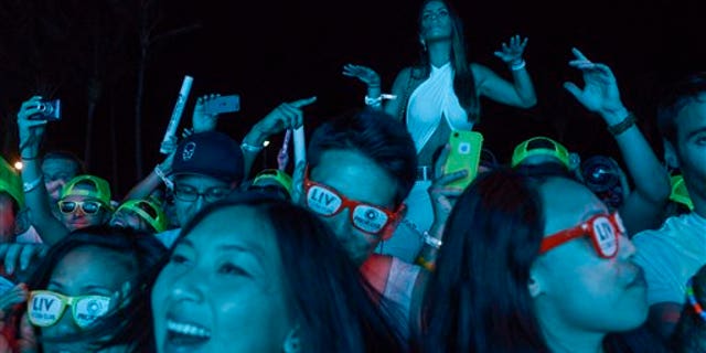 IMAGE DISTRIBUTED FOR NEON SPORT - The crowd dances to the music during Miami Reboot party which kicked off Ultra, the Electronic Music Dance festival during Miami Music Week on Thursday March 27, 2014 in South Beach, Miami. Attended by over 2,000 people, Miami Reboot was sponsored by Protocol Recordings and Neon Sport, sports nutrition drink from Cellucor. (Josh Ritchie/AP Images for Neon Sport)