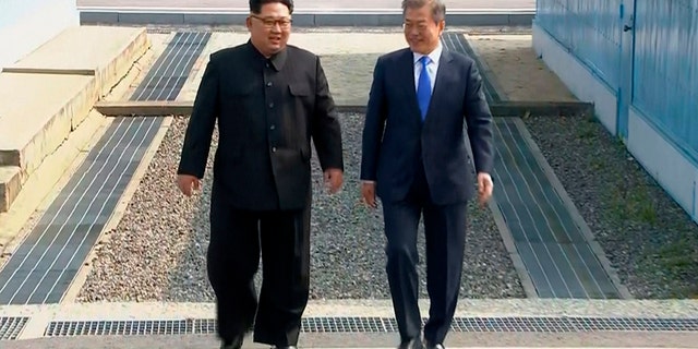 North Korean leader Kim Jong Un, left, and South Korean President Moon Jae-in walk together as Kim crossed the border into South Korea for their historic face-to-face talks, in Panmunjom. Their discussions will be expected to focus on whether the North can be persuaded to give up its nuclear bombs.