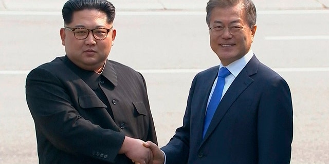 North Korean leader Kim Jong Un, left, shakes hands with South Korean President Moon Jae-in as Kim crossed the border into South Korea for their historic face-to-face talks, in Panmunjom.