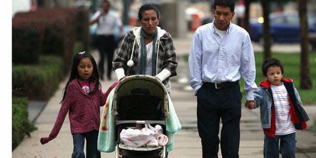 Undocumented Mexican immigrant Jeanette Vizguerra (L), her husband Salvador and their children Luna, 7, and Roberto, 5, walk to her immigration hearing in federal court on July 13, 2011 in Denver, Colorado.
